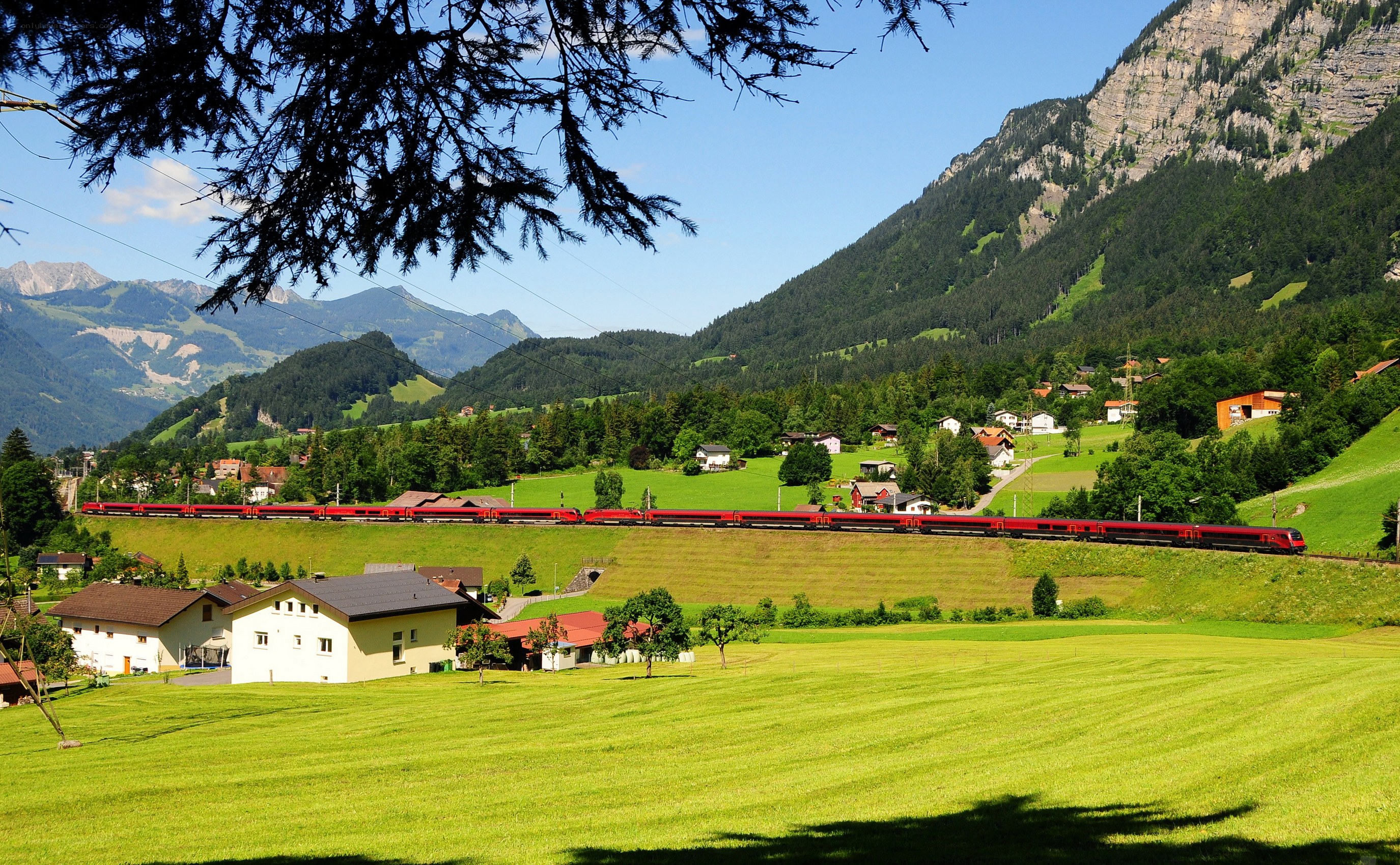 Red train in mountain valley