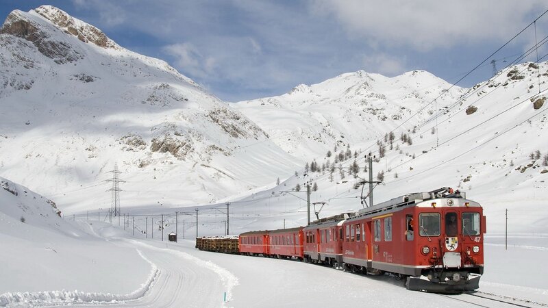 Red Train in Snow — Serene, Winter, Photograph, Snow-covered Mountains, Train Tracks, Power Lines, Trees