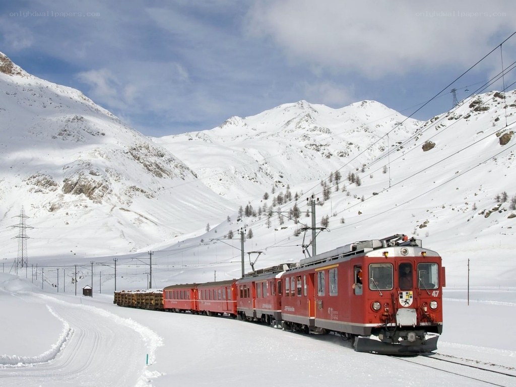 Red train in snowy mountains