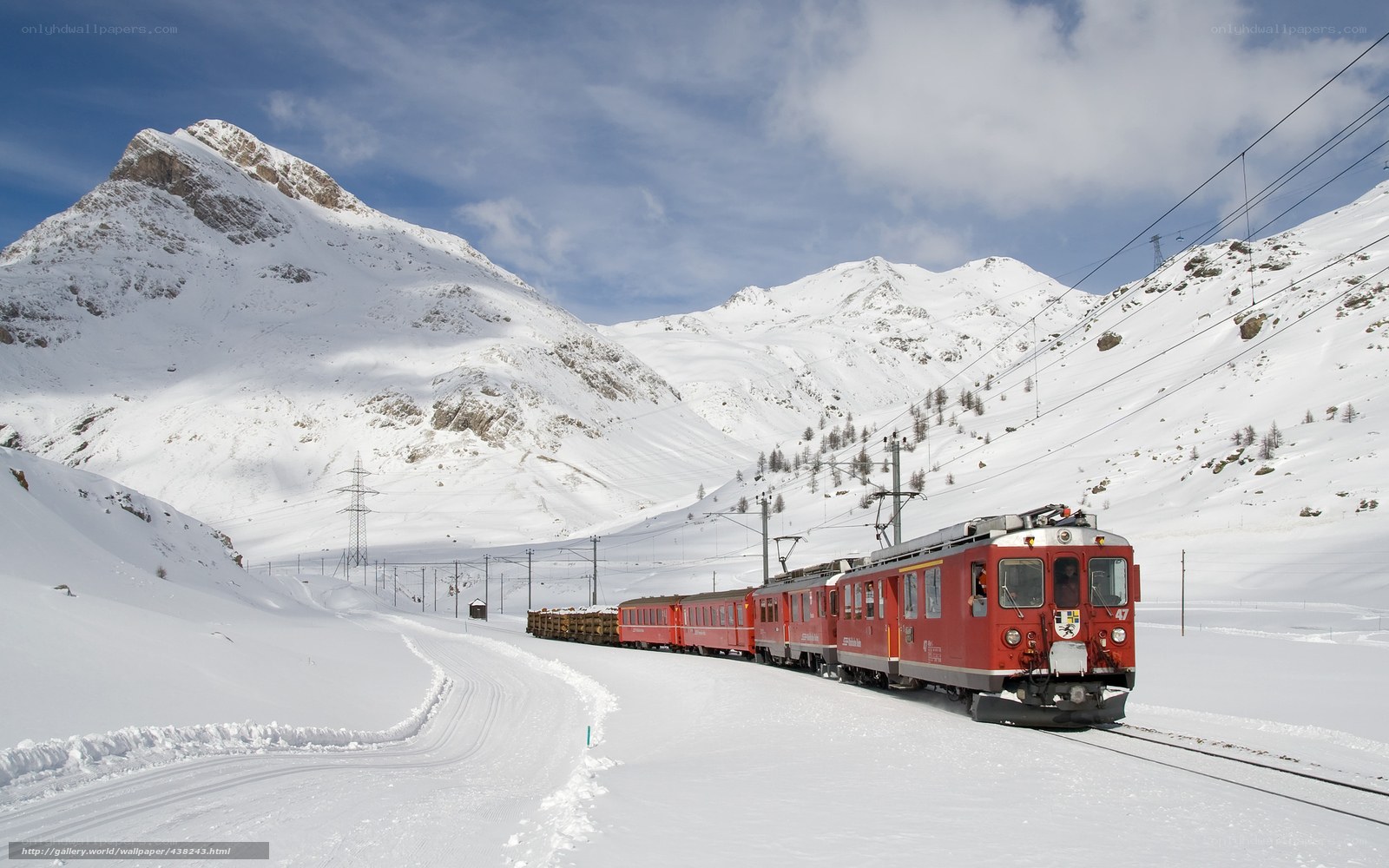Red train in snowy mountains