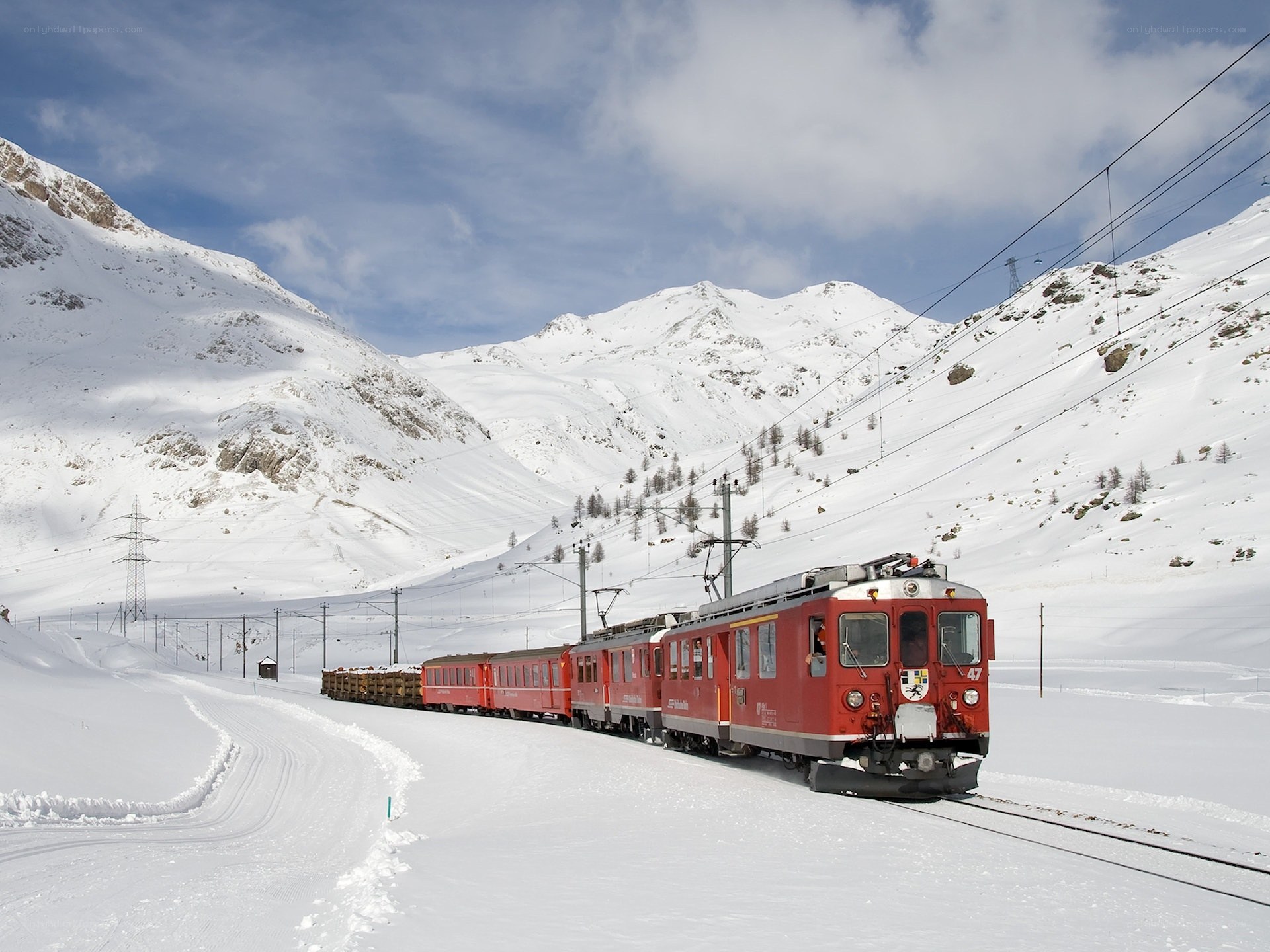 Red train in snowy mountains