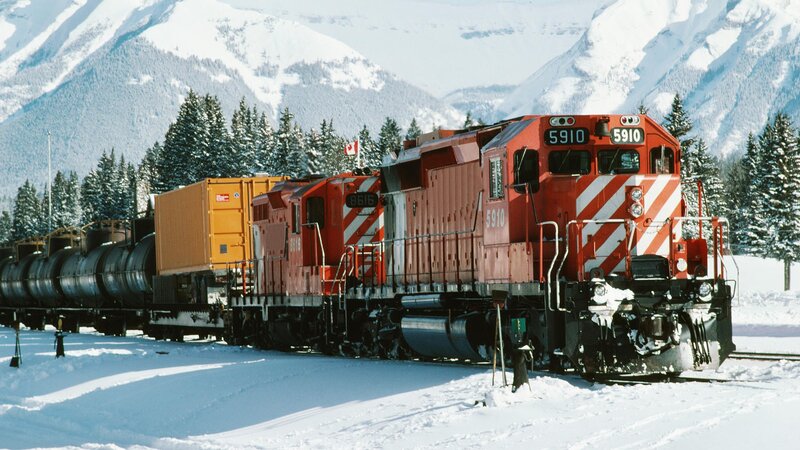 Red train in snowy mountains