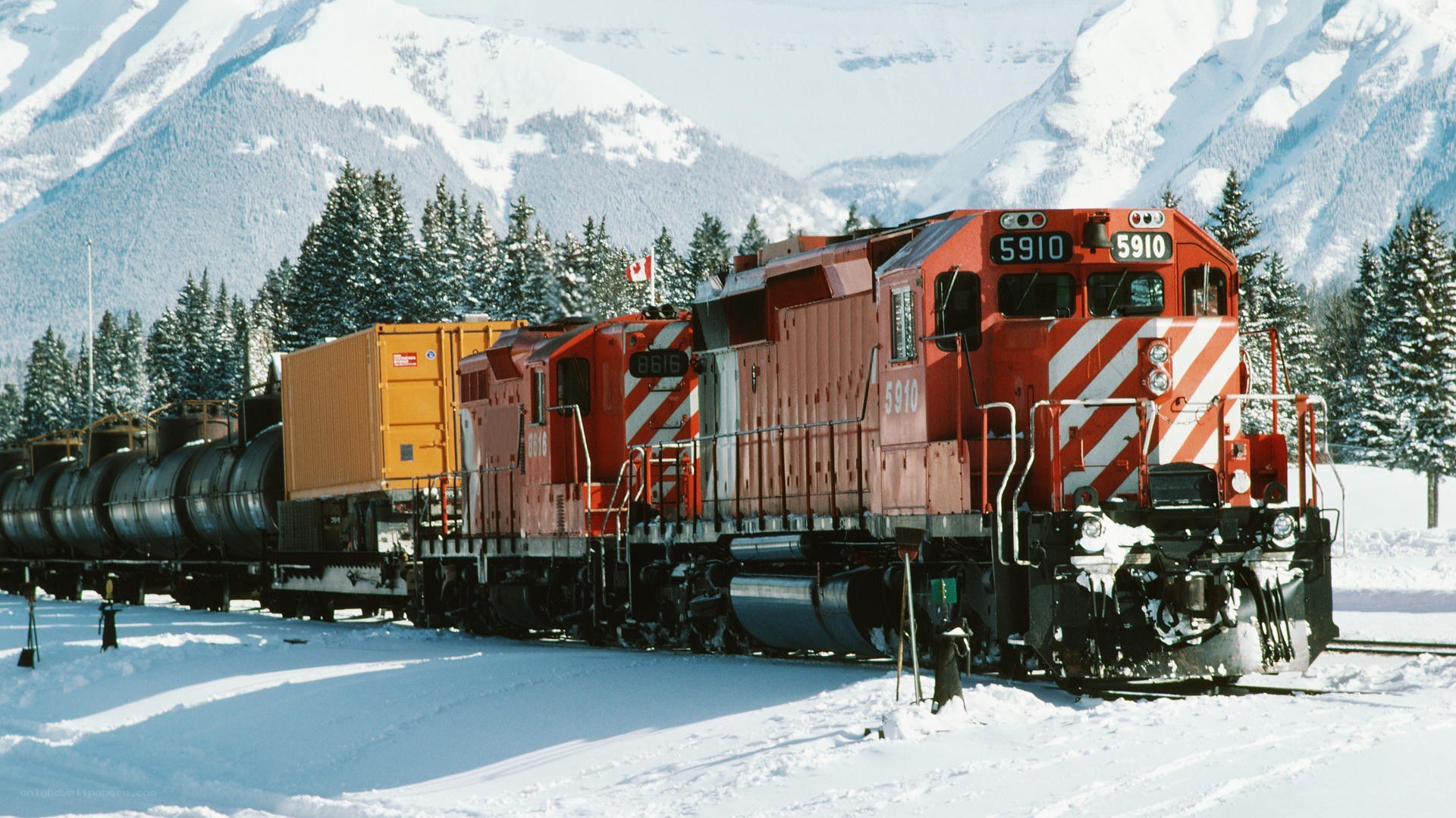 Red train in snowy mountains