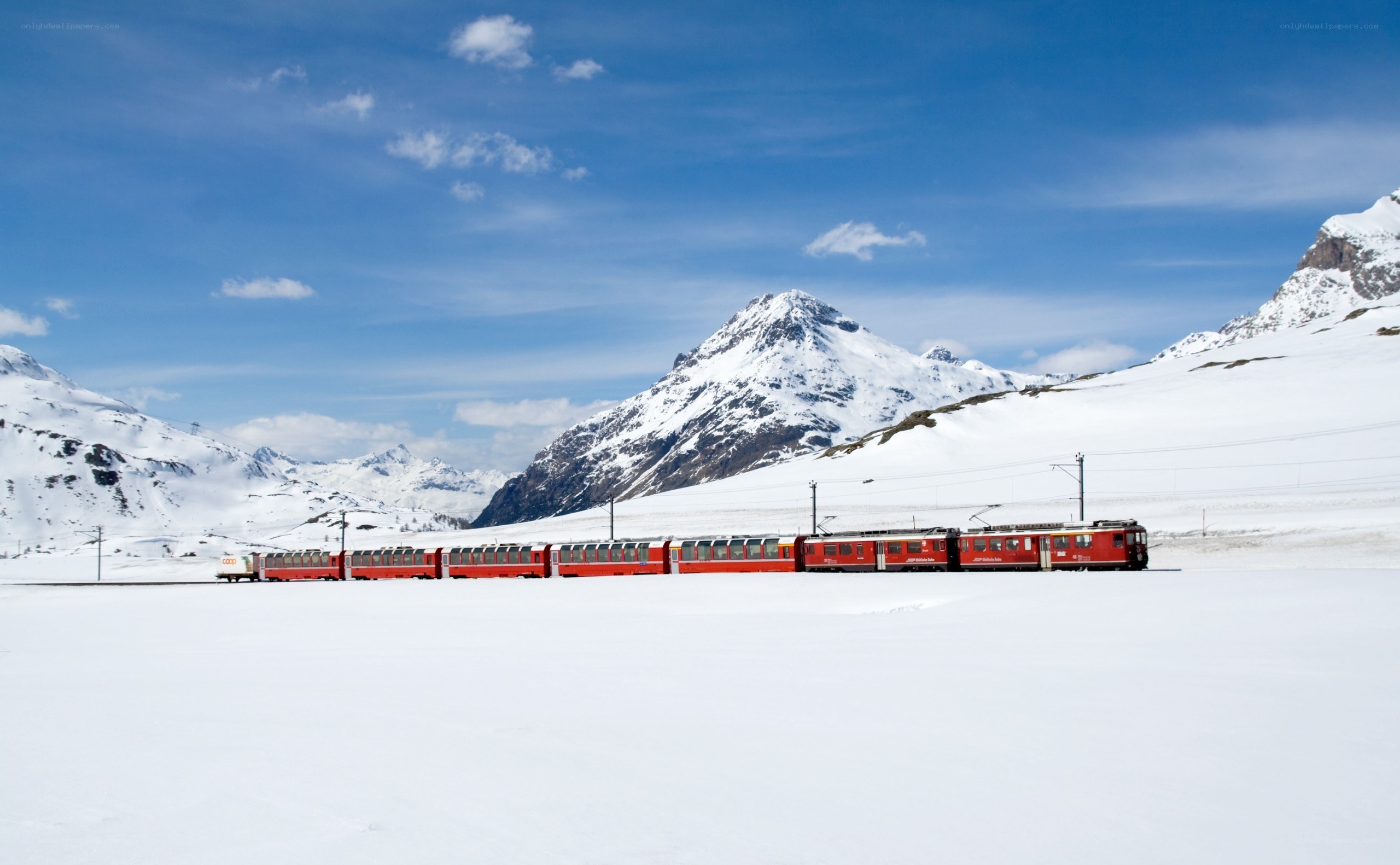 Red train in snowy mountains