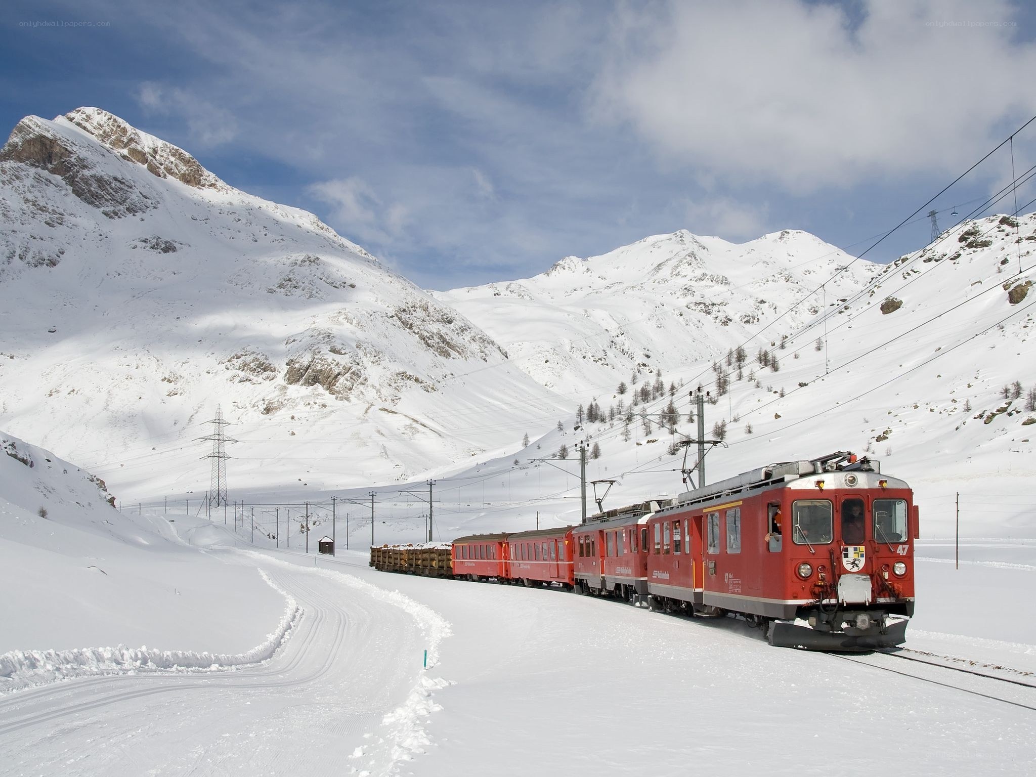 Red train in snowy mountains