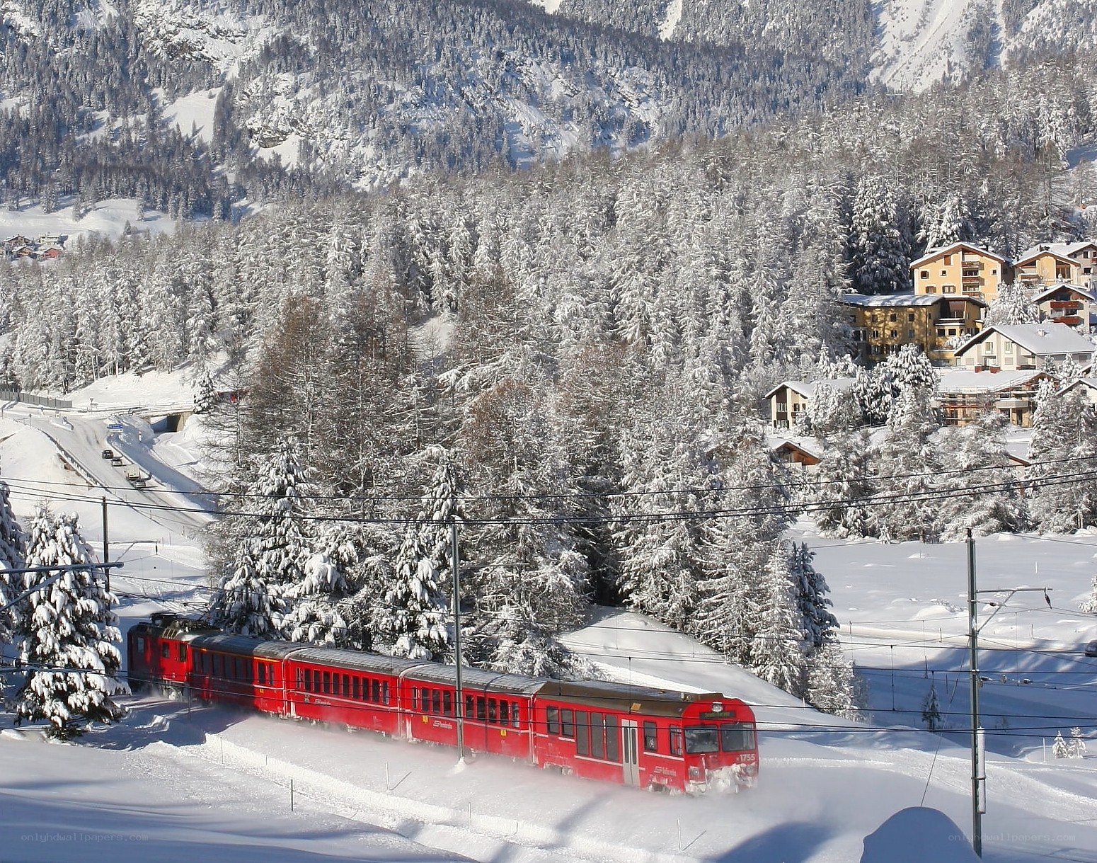 Red train in snowy mountains