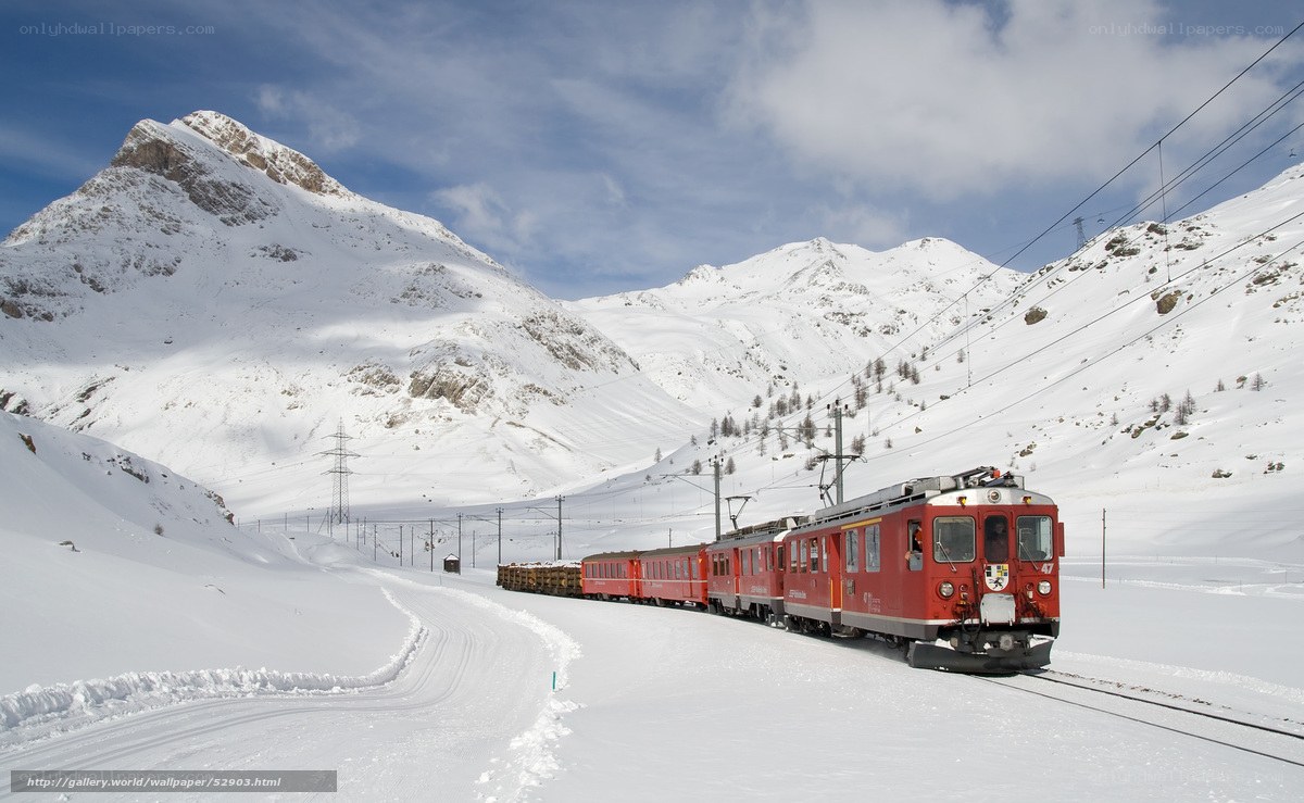 Red train in snowy mountains