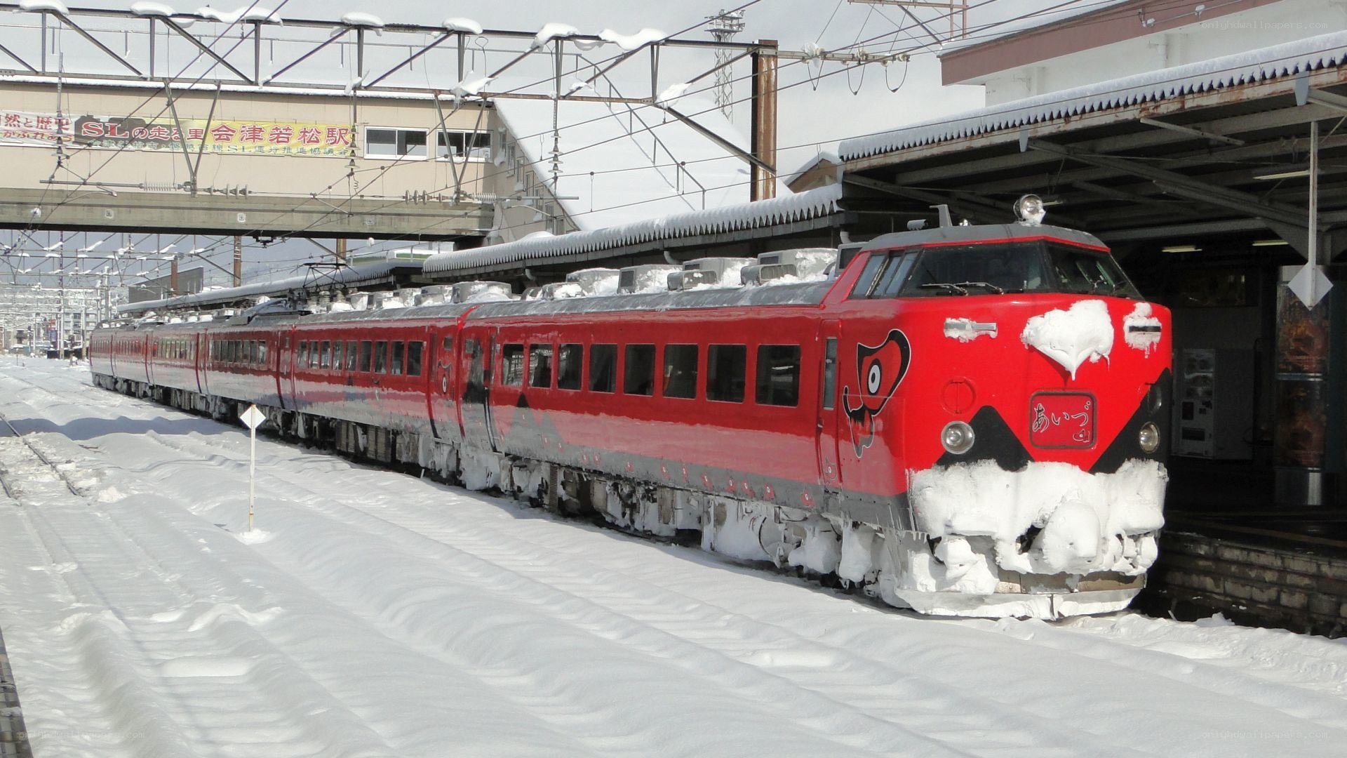 Red train in snowy station