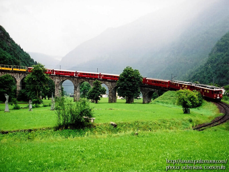 Red train on a stone bridge