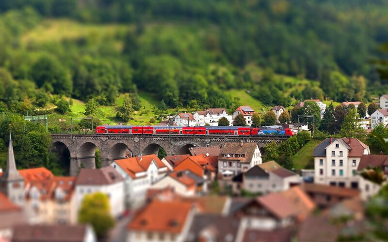 Red Train on Bridge — Green, Serene, Afternoon, Photograph, Town, Hills, Brown