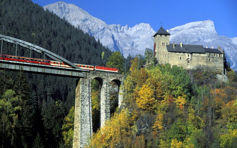 Red Train on Bridge — Green, Serene, Autumn