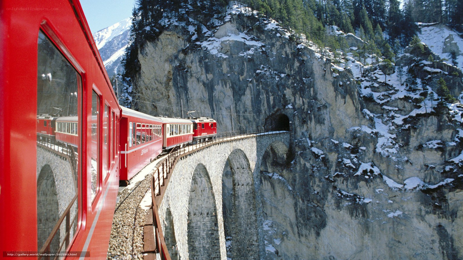 Red train on mountain bridge