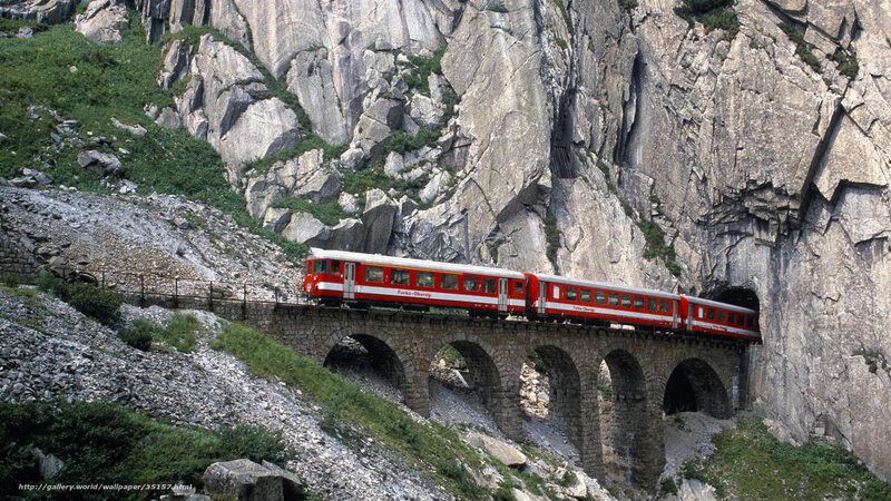 Red train on mountain bridge