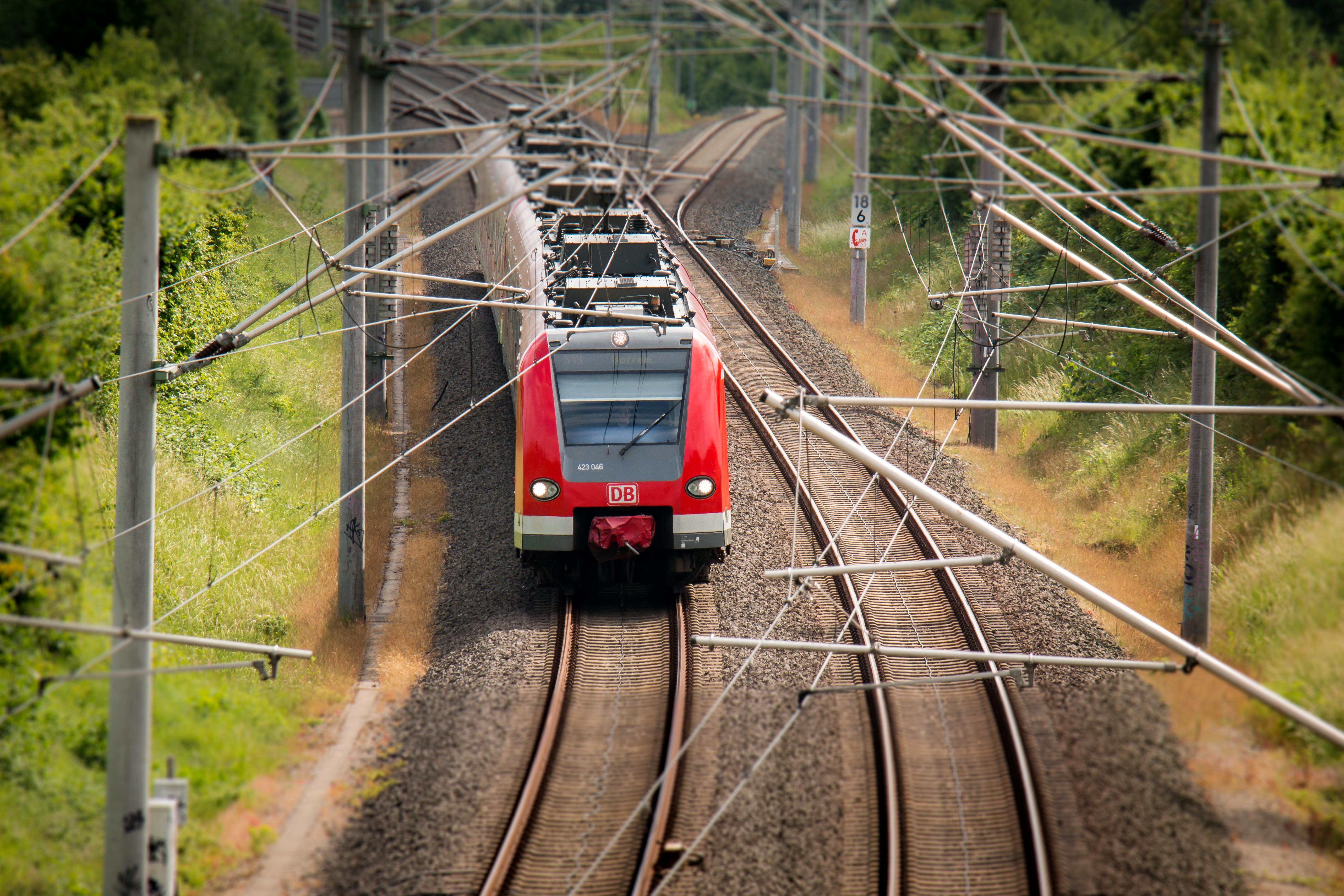 Red train on railway tracks