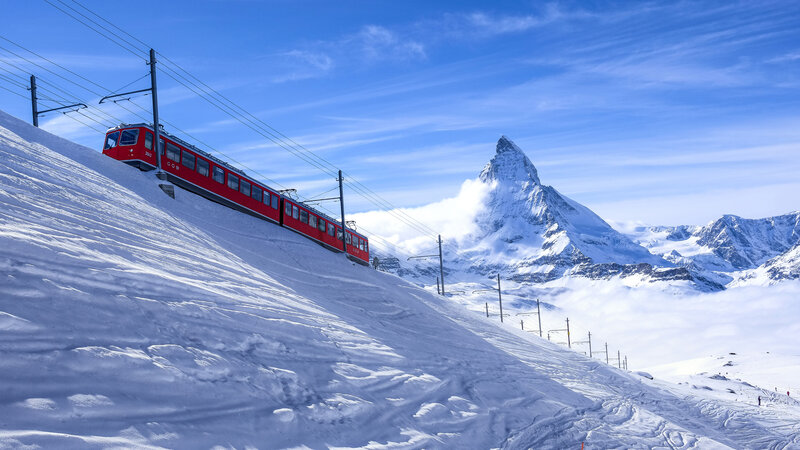 Red Train on Snowy Slope