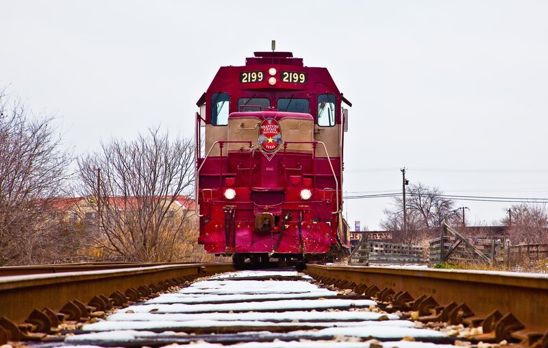 Red train on snowy tracks
