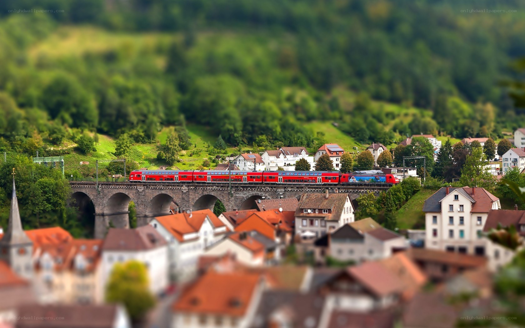 Red train on stone bridge