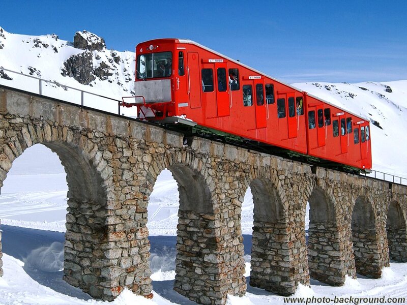 Red train on stone bridge