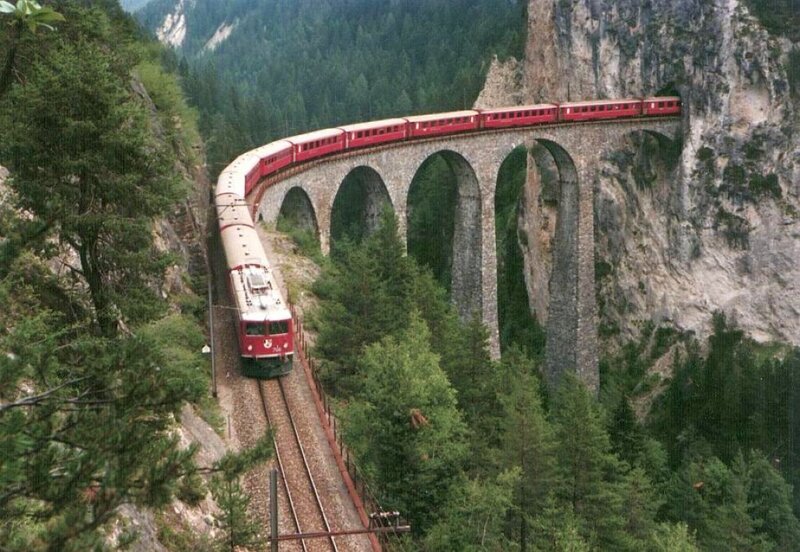 Red Train on Viaduct — Dramatic