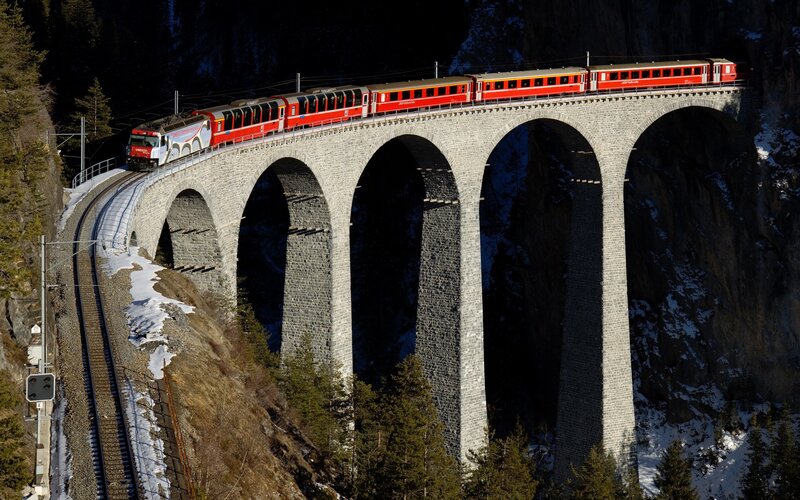 Red Train on Viaduct — Dramatic, Winter, Photograph, Mountain, Trees, Snow