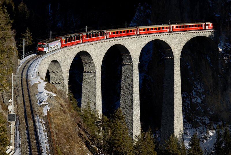 Red Train on Viaduct — Dramatic, Winter, Photograph, Mountain, Trees