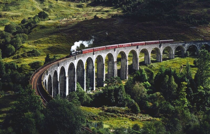 Red Train on Viaduct — Green, Serene
