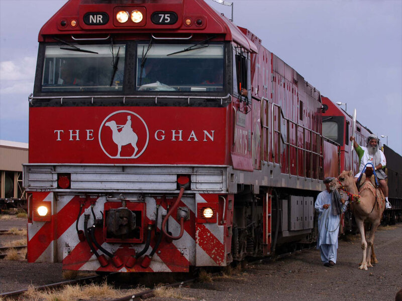 Red train with camel riders
