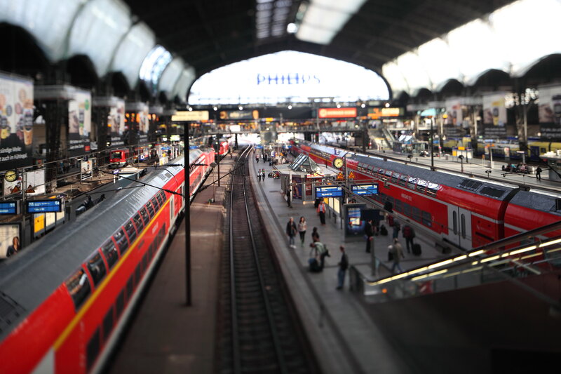 Red trains at a busy station