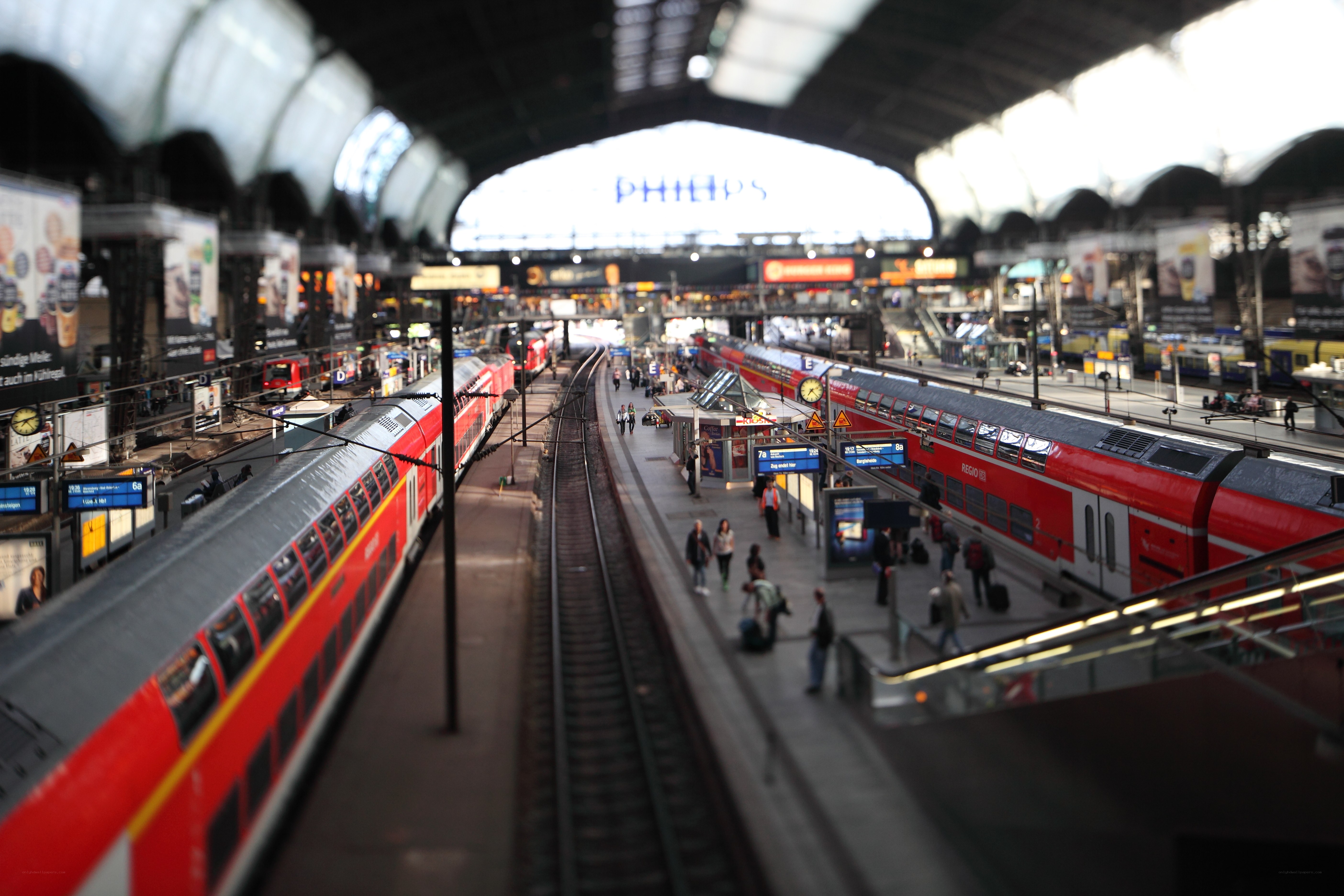 Red trains at a busy station