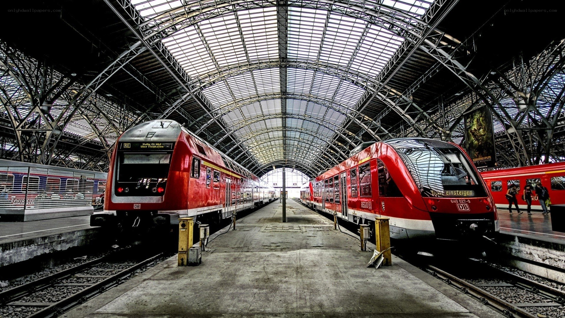 Red trains at a large station