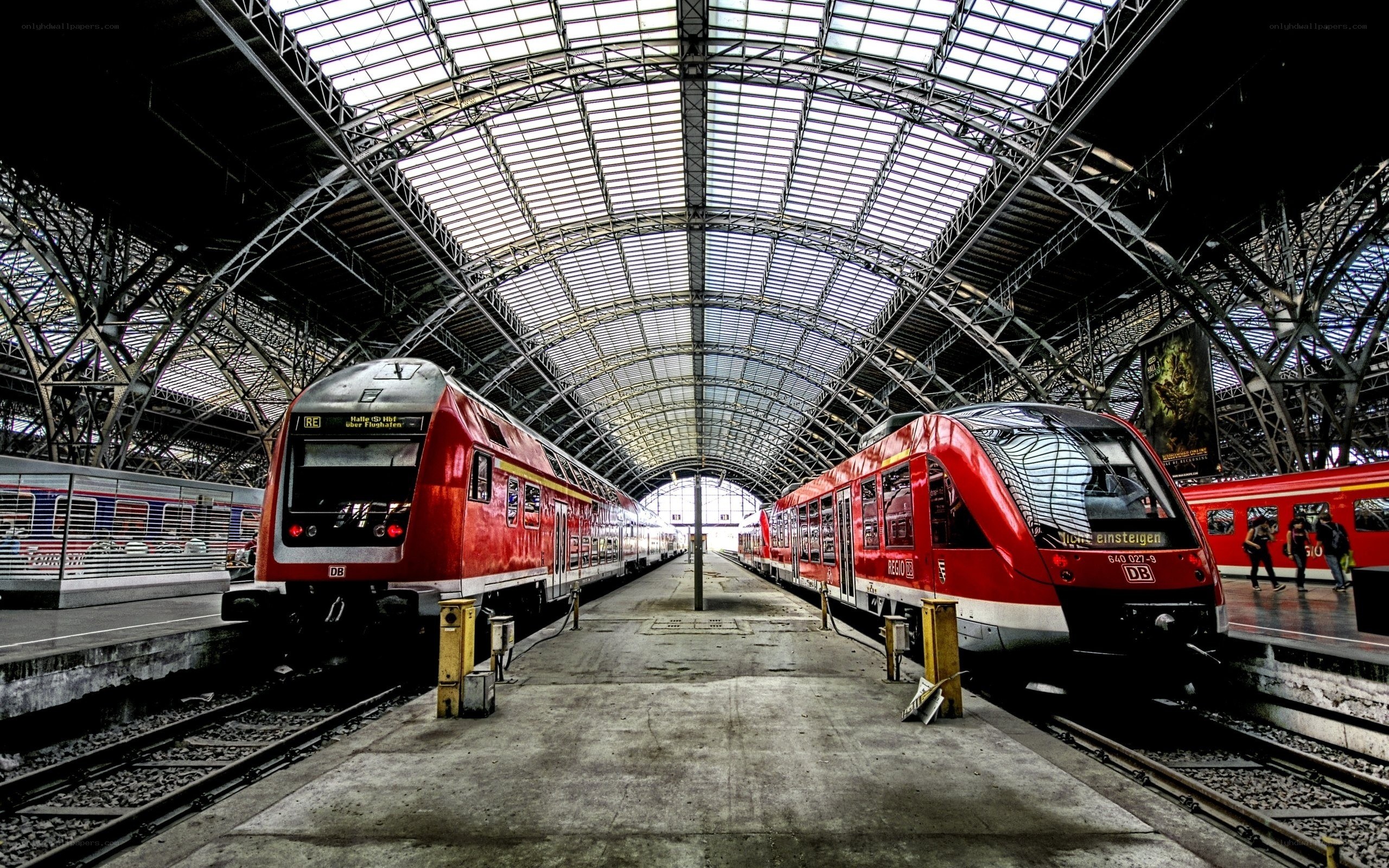 Red trains at a station