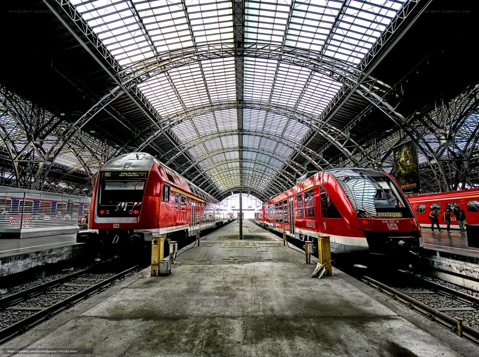 Red trains in a train station