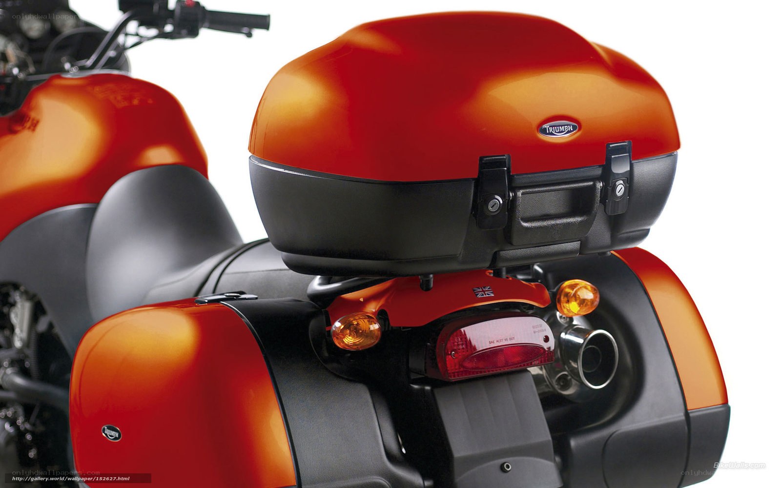Red Triumph motorcycle with luggage