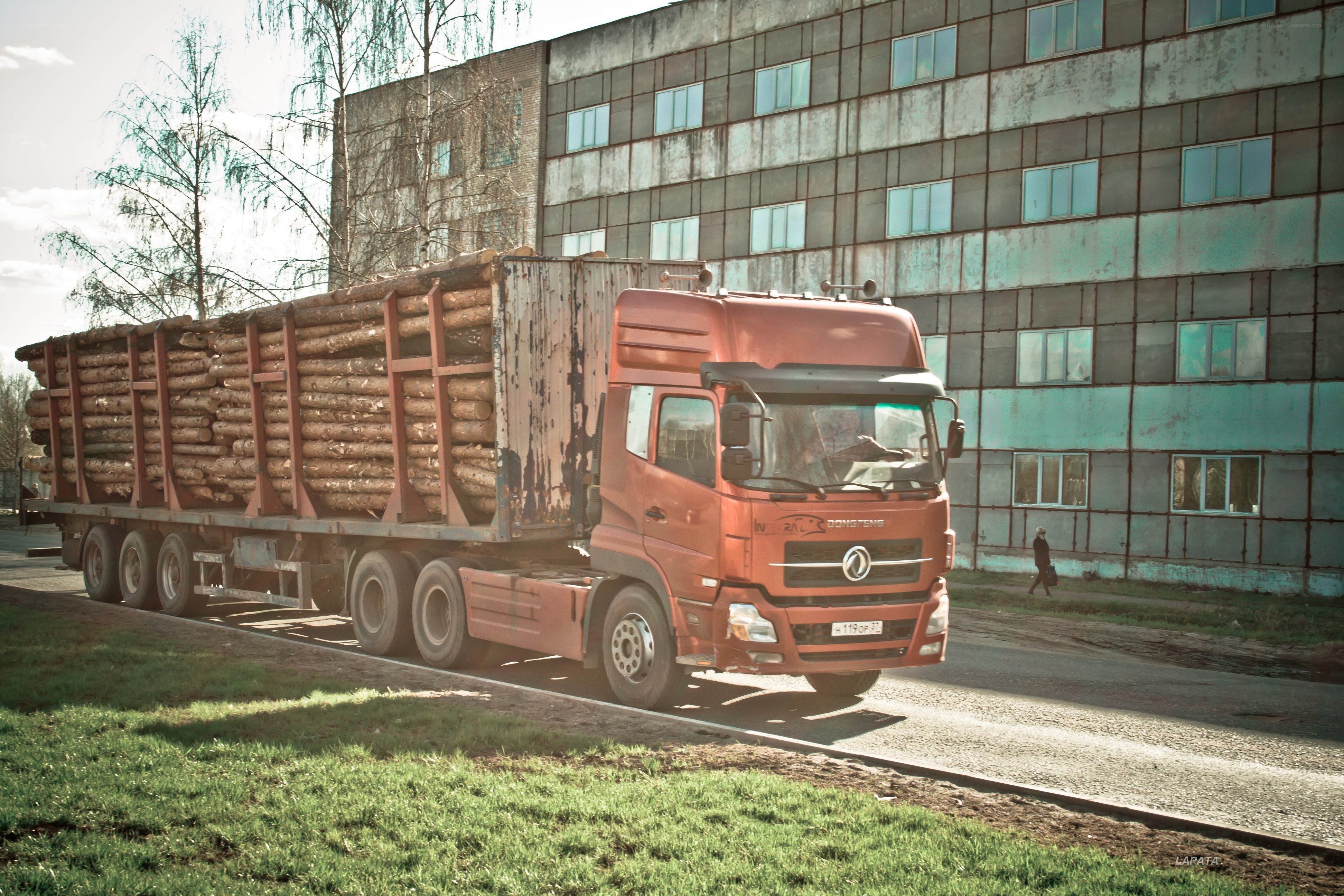 Red truck carrying logs