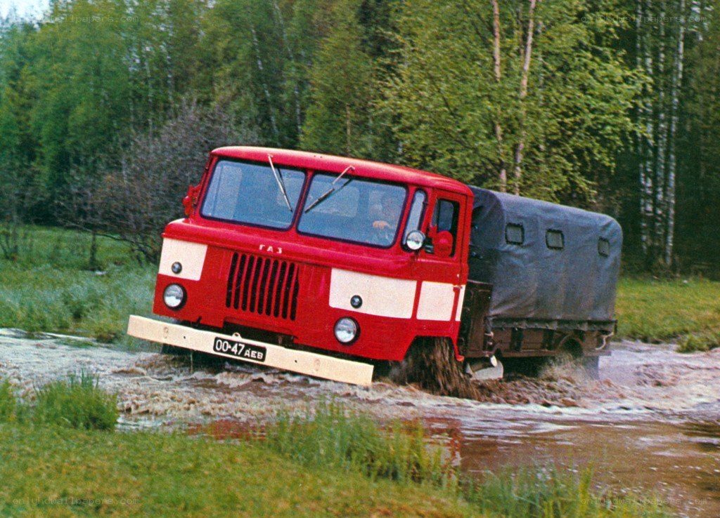 Red truck crossing a stream