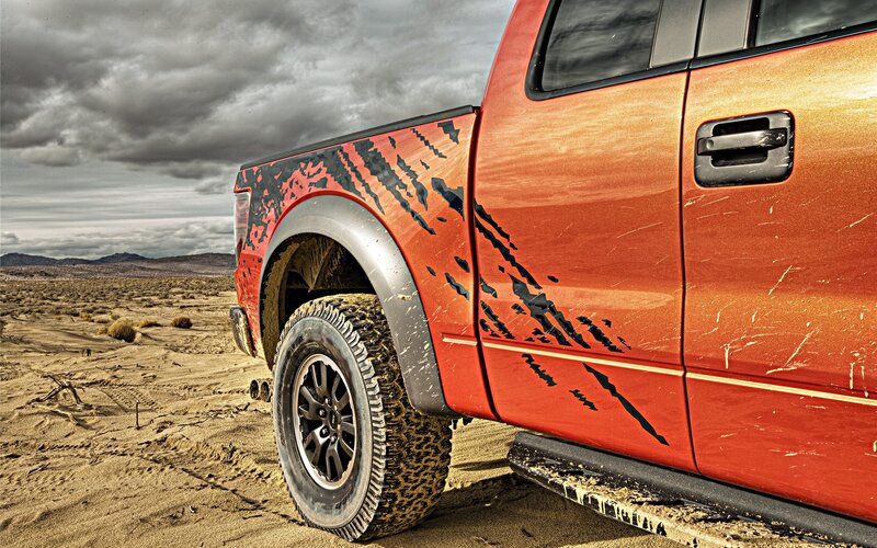 Red truck in desert landscape