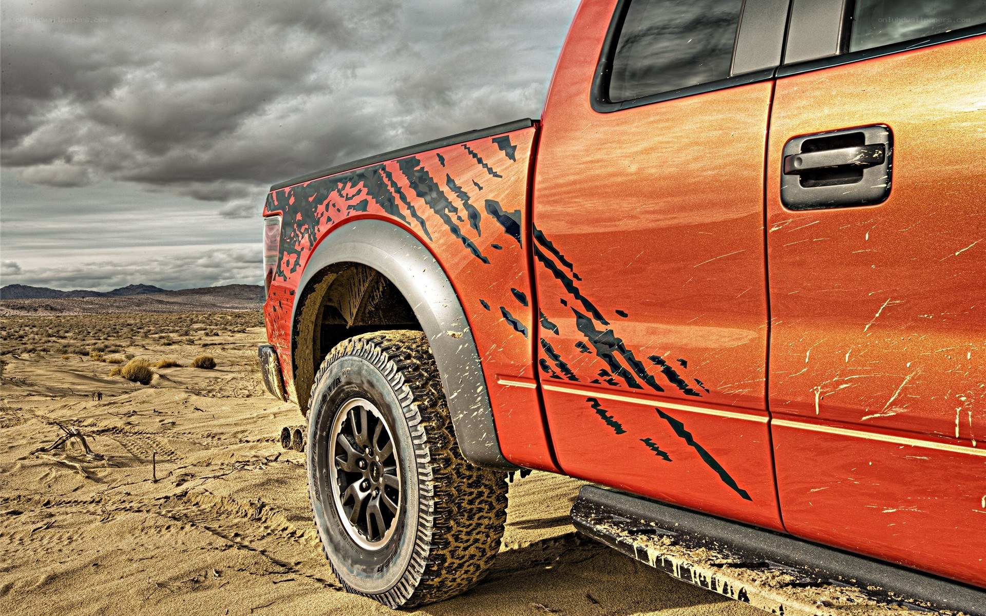 Red truck in desert landscape