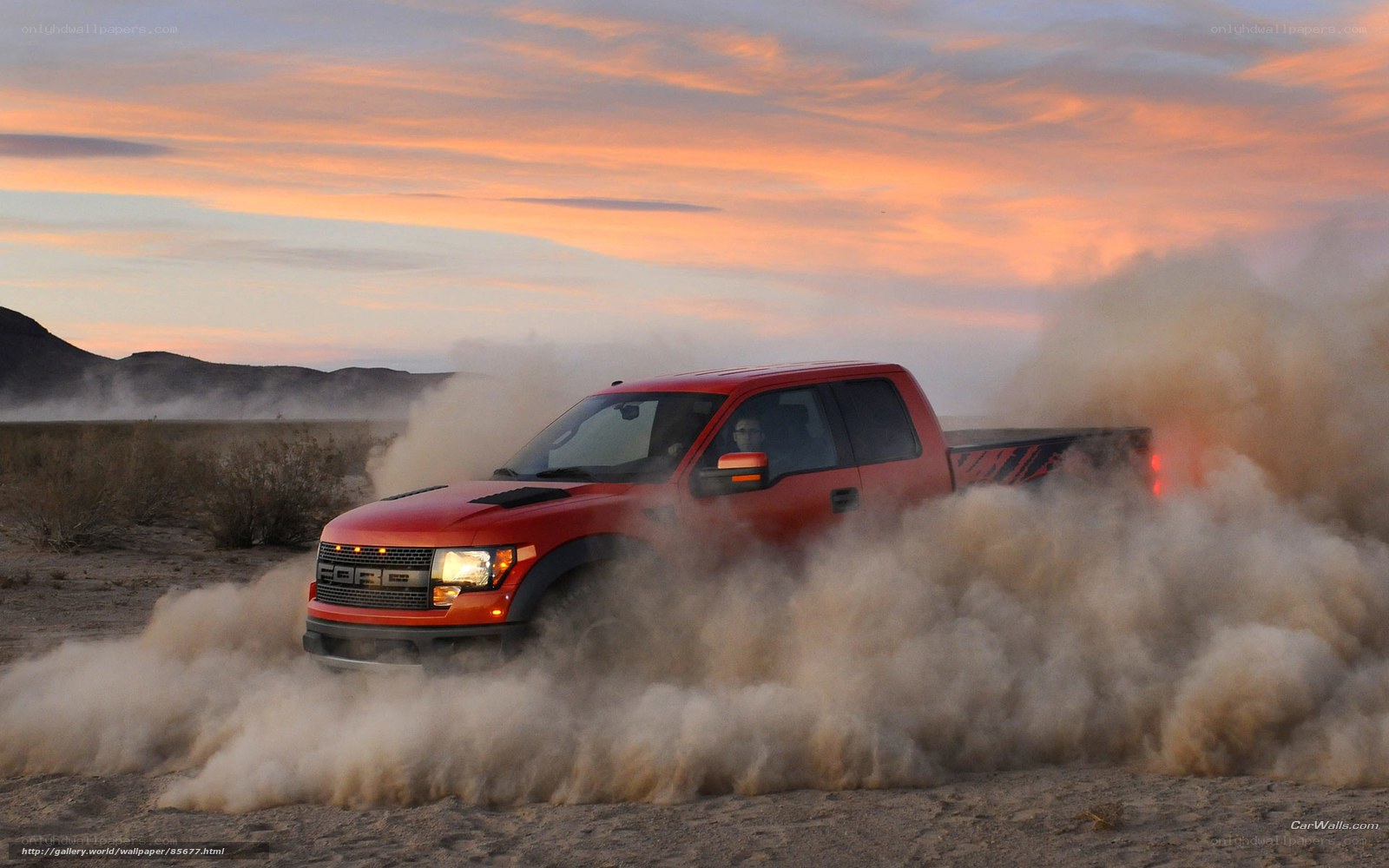 Red truck kicking up dust