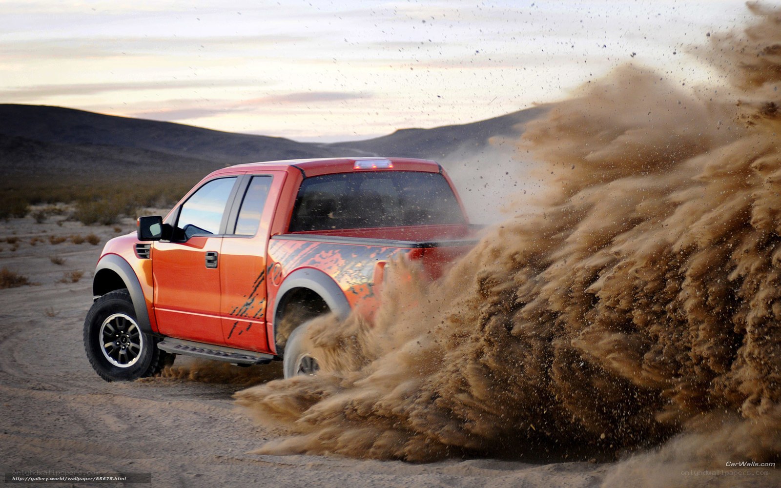 red truck kicking up dust
