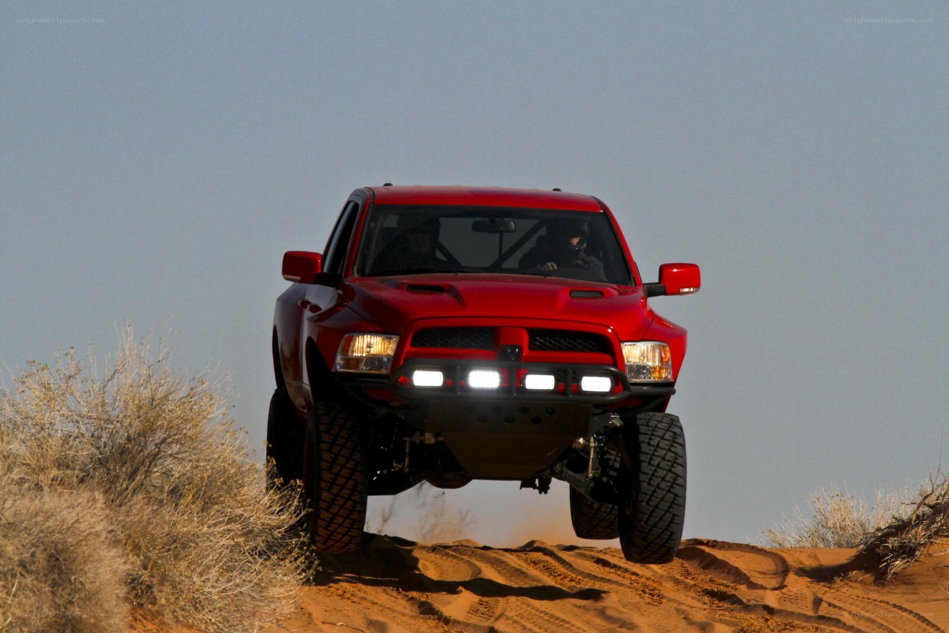 Red truck on sand dune