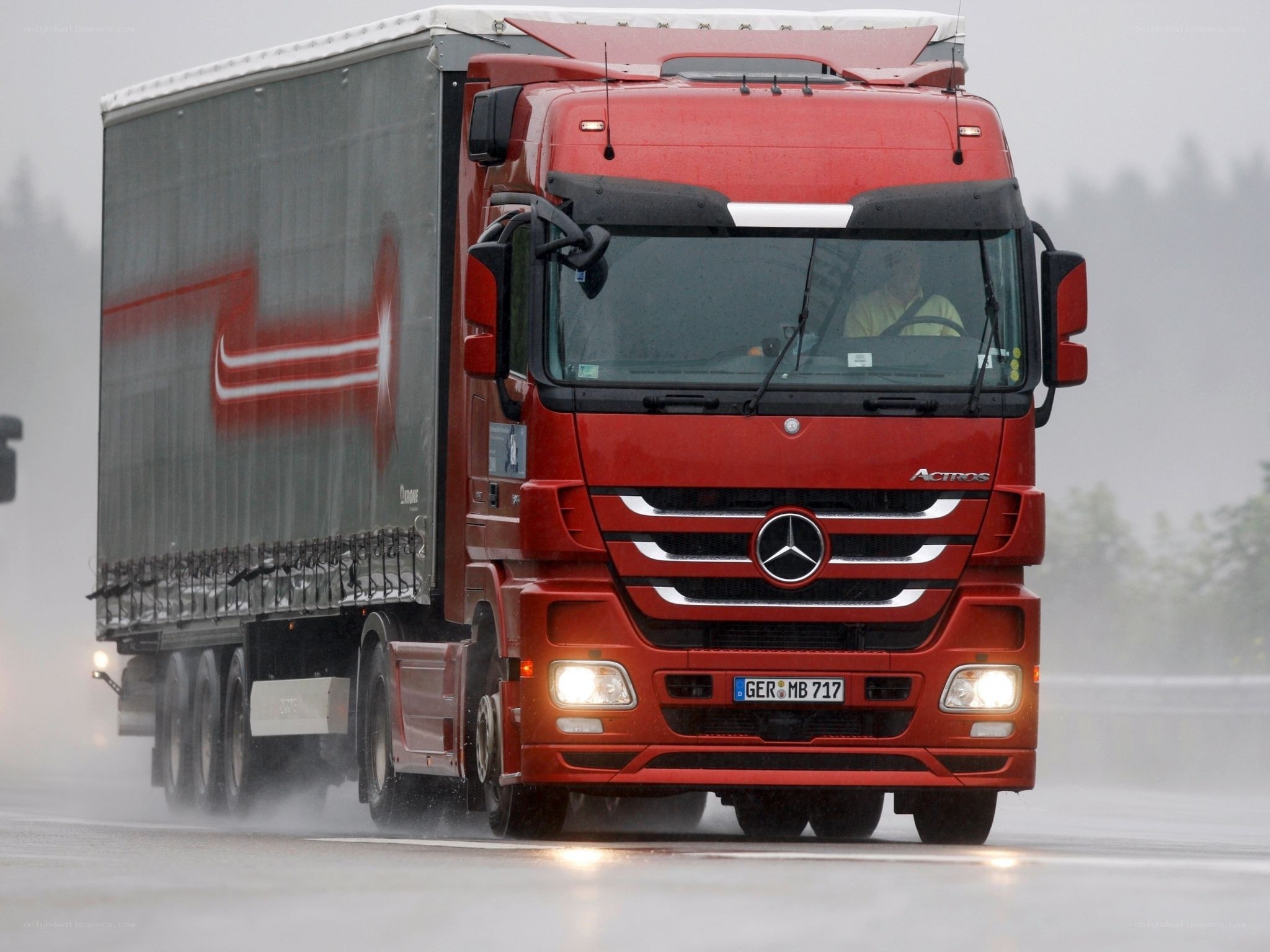 Red truck on wet road