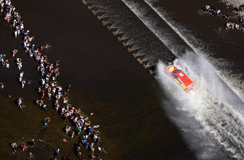 Red truck splashing through water