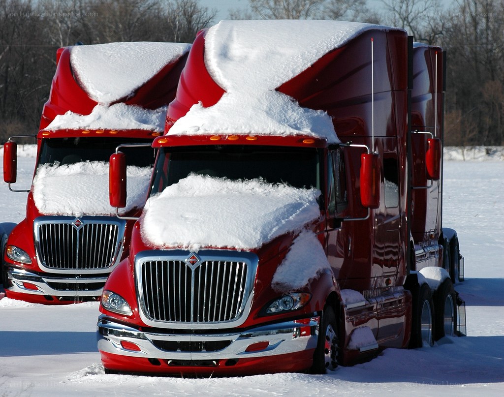 Red trucks in snowy field