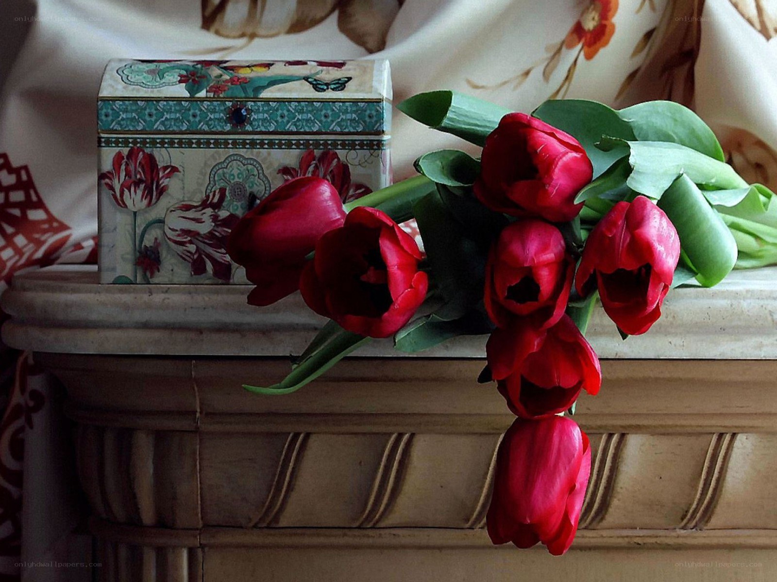 Red tulips on a mantel
