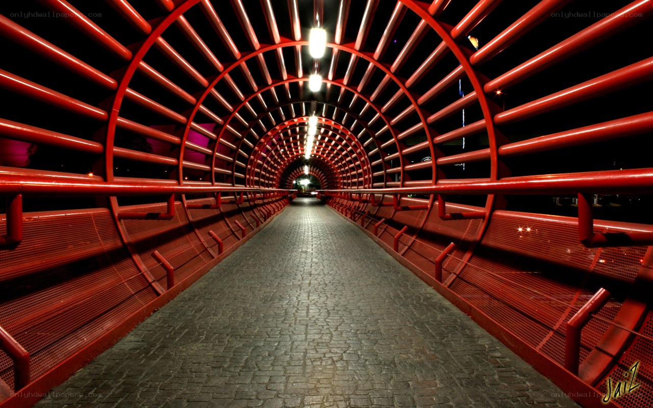 Red tunnel bridge at night