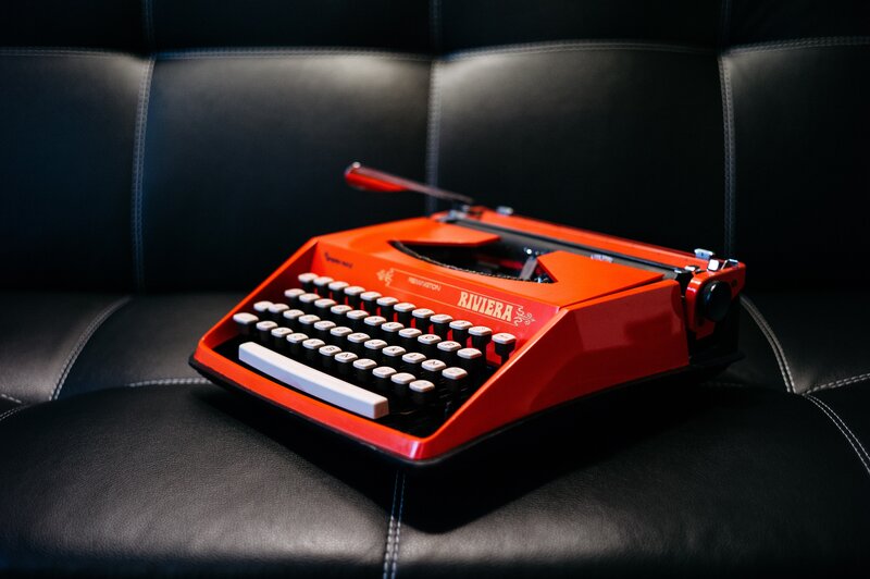 Red typewriter on black leather