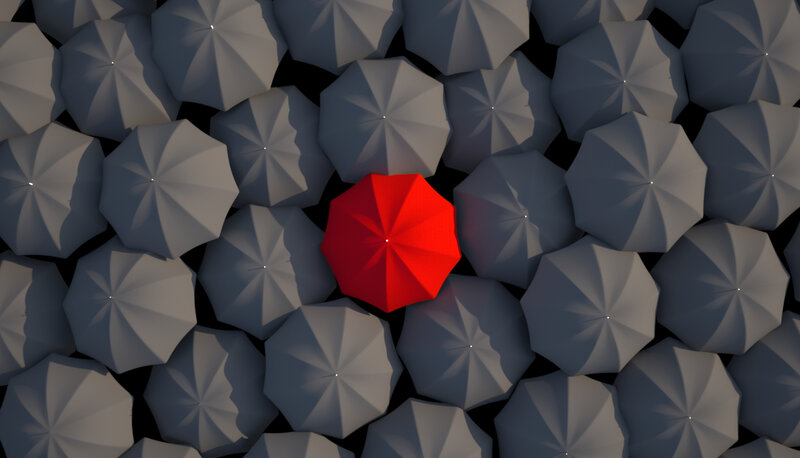 Red Umbrella Among Gray Ones