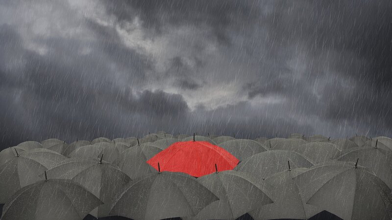 Red umbrella in a crowd