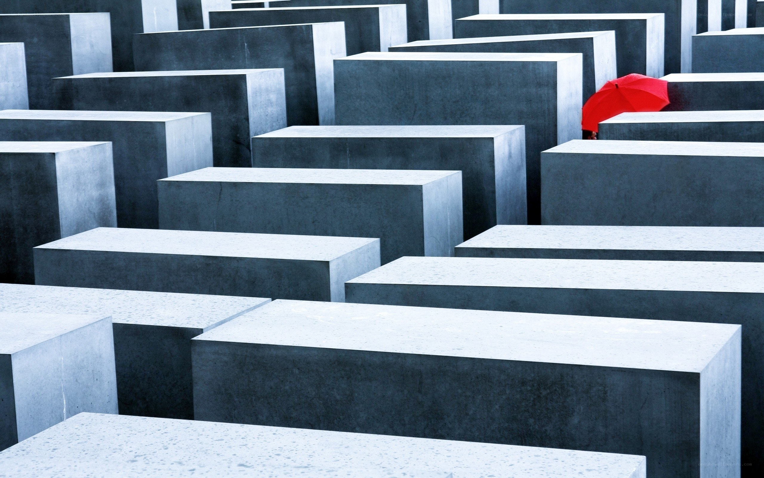 Red umbrella in a stone maze