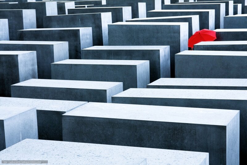 Red umbrella in a stone maze